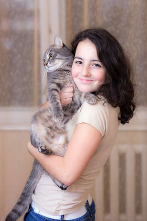 portrait of a teenage girl with a pet catの写真素材