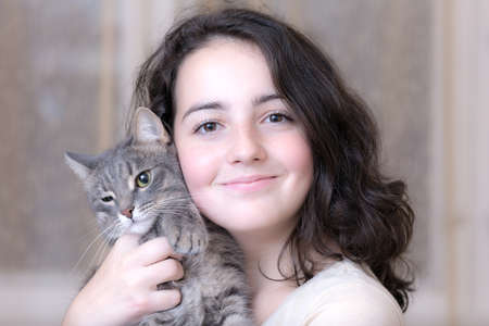 portrait of a teenage girl with a pet cat closeupの写真素材