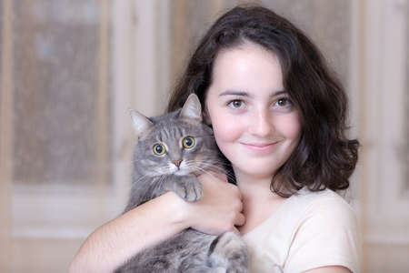 portrait of a teenage girl with a pet cat closeupの写真素材