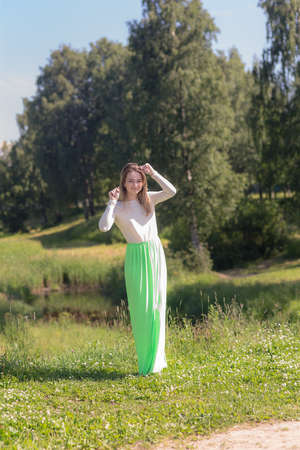 portrait of a slender girl in a summer parkの写真素材