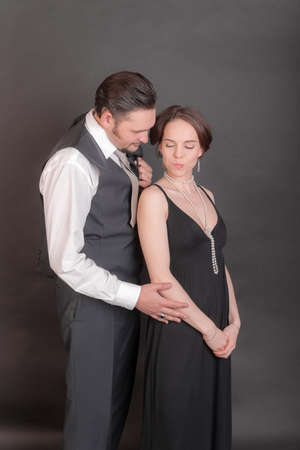 studio portrait of a couple on a black backgroundの写真素材