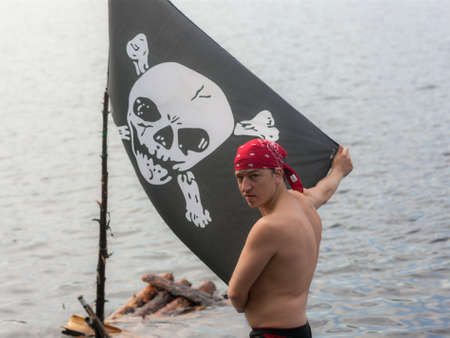 man on the lake with a pirate flagの写真素材