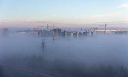morning fog in the city at the construction siteの写真素材