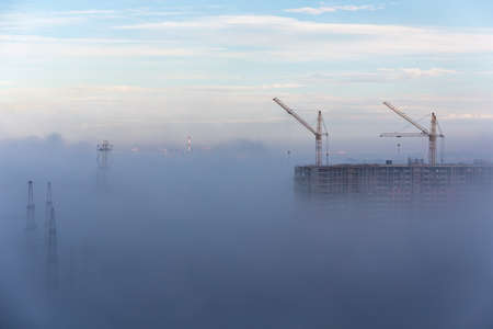 morning fog in the city at the construction siteの写真素材