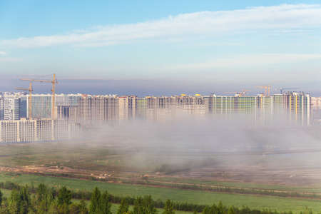 morning fog in the city at the construction site