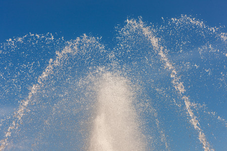 abstract splashing fountain on blue sky backgroundの写真素材