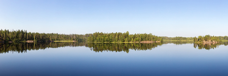 panorama of a forest lake in the calm of a summer dayの写真素材