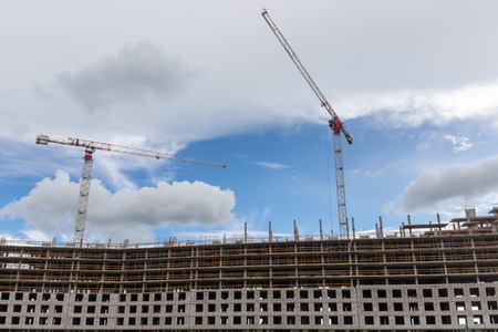 construction site with cranes on sky background