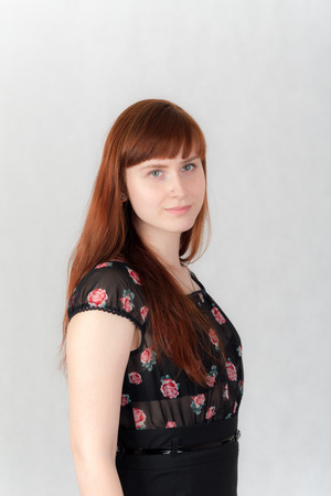 portrait of a girl with red hair in a black dressの写真素材