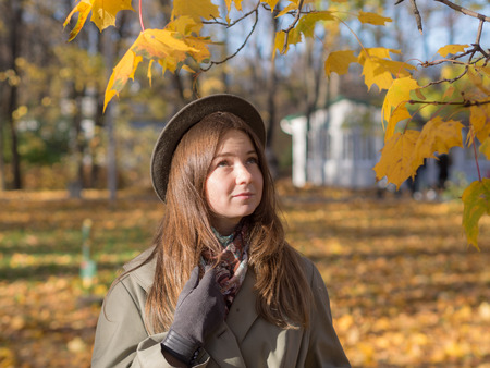 portrait of a girl in a hat in autumn park