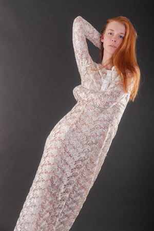 studio portrait of slim girl in white dressの写真素材