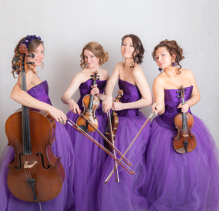 studio portrait of a musical quartet with instrumentsの写真素材