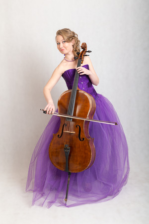 studio portrait of a female musician with a celloの写真素材