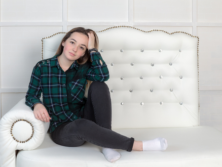 studio portrait of a girl on the couchの写真素材