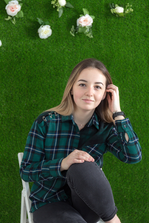 studio portrait of a girl on a green backgroundの写真素材