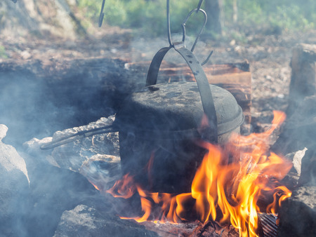 kettle over the fire in the hearth of stonesの写真素材