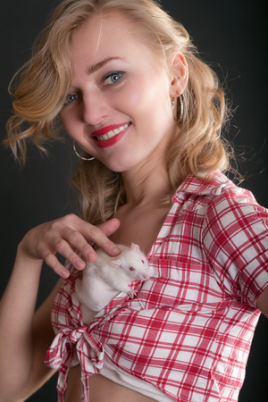 portrait of a girl with a white domestic ratの写真素材