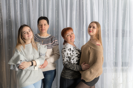 studio portrait of two moms and daughtersの写真素材