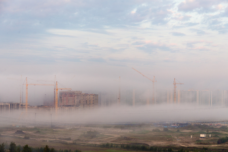 morning fog over a construction site in the cityの写真素材