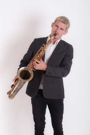 studio portrait of a musician with saxophoneの写真素材