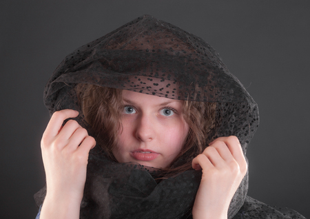 studio portrait of a teenager girl on a black backgroundの写真素材