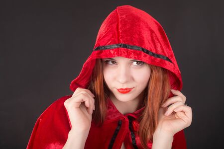 studio portrait of a girl in a red hood