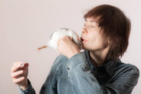 Portrait of a woman with domestic ratの写真素材