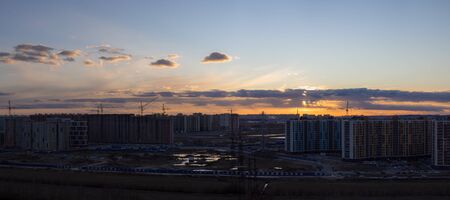 bright sunset over the city and the construction siteの写真素材