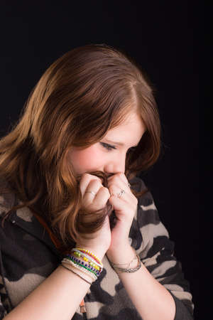 portrait of a teenager girl on a black background