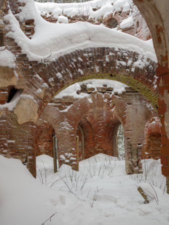 arches in the ruins of a noble estate under the snow, Russia, Leningrad region, the village of Torosovoの写真素材