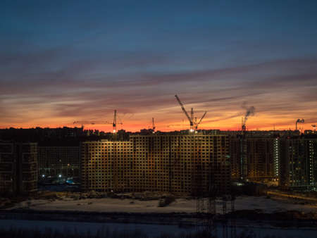 dramatic sunset over a construction site in the city