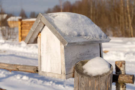 rural wooden mailbox close up in winterの写真素材