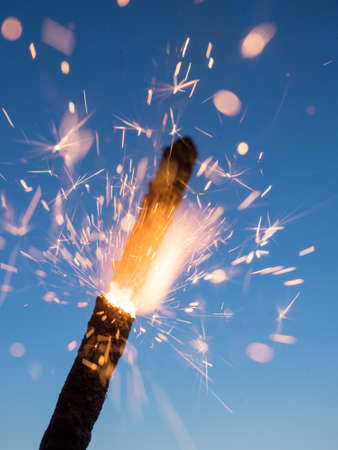firework sparks on blue sky background closeupの写真素材