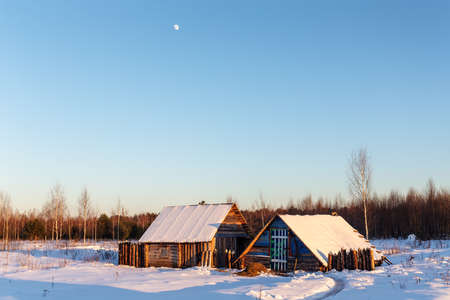 rural landscape with wooden buildings on a sunny winter dayの写真素材