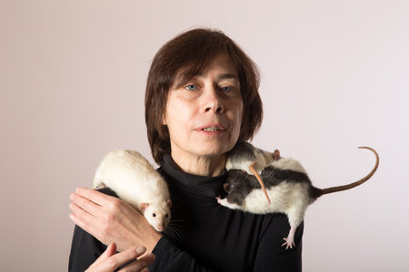 studio portrait of a woman with domestic ratsの写真素材