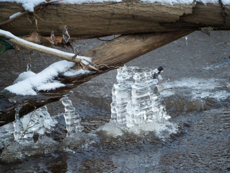 icicles over river water on a cold day close upの写真素材