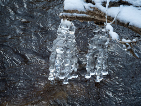 icicles over river water in winter closeupの写真素材