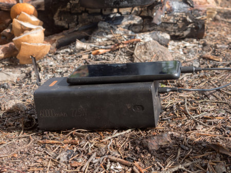 using a power bank to charge your phone in the wildernessの写真素材