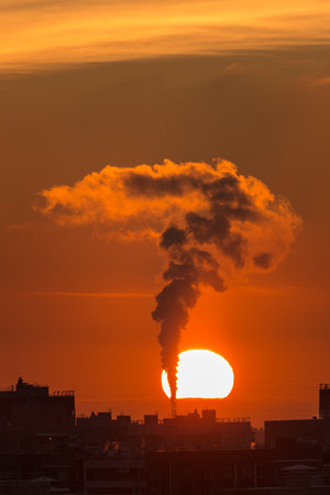 bright sunset with sun over the city rooftopsの写真素材