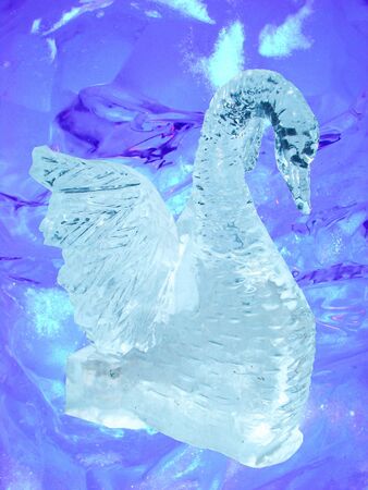 Sculpture a swan which has been cut out from the ice on an ice backgroundの写真素材