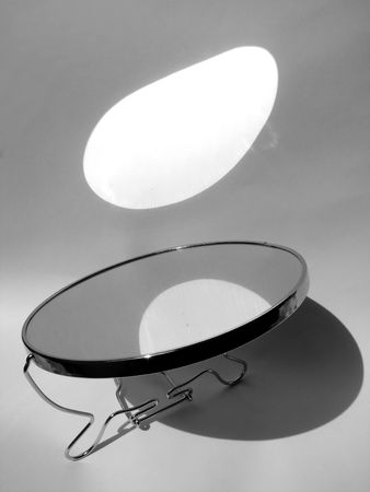 Game of light and shade. Mirror and sun young hare on a wallの写真素材