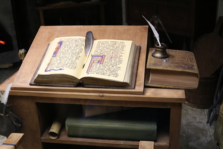alchemist table with scrolls and with an open bookのeditorial素材