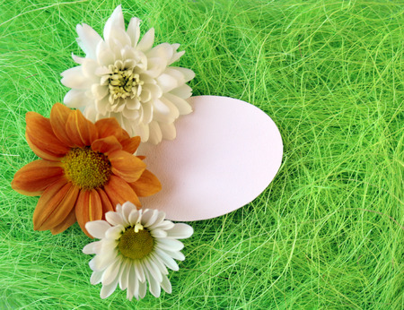 chrysanthemum flowers on a green sisal fiber with a sign