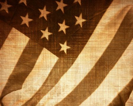 worn wamerican flag waving in the windの写真素材