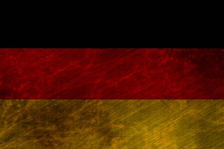 worn german flag waving in the windの写真素材