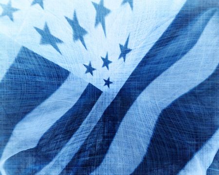 worn american flag waving in the windの写真素材