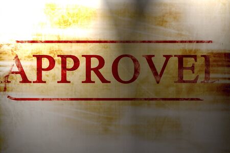 approved stamp on a paper like backgroundの写真素材