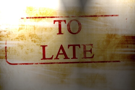 too late stamp on a paper like backgroundの写真素材