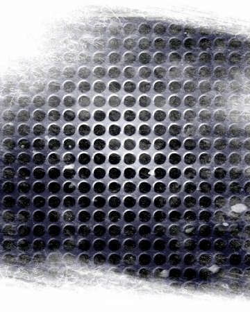 metal grid with some holes in itの写真素材