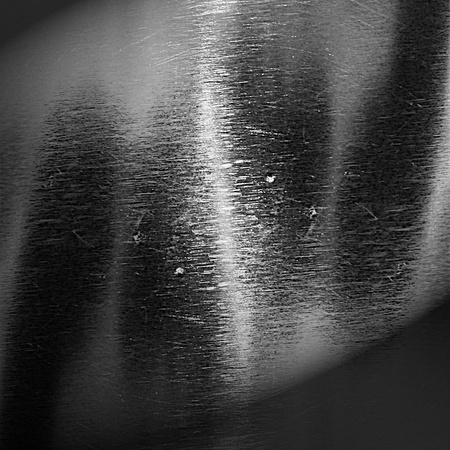 metal background texture with some shades and highlights on itの写真素材